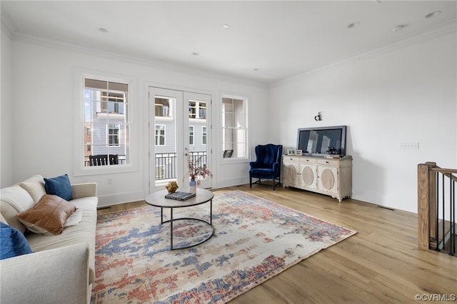 living room with crown molding and light hardwood / wood-style floors