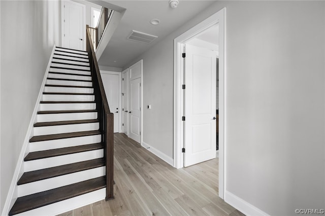 staircase featuring light hardwood / wood-style floors