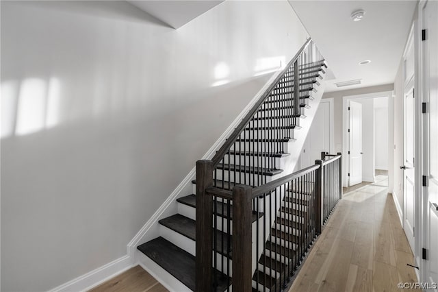 staircase featuring light hardwood / wood-style floors