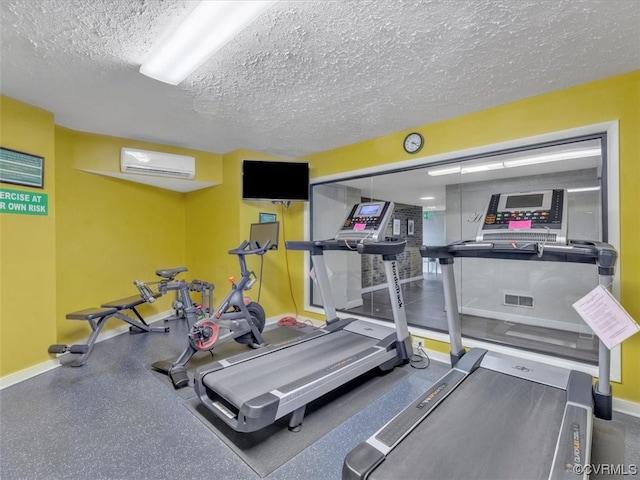 workout area featuring a textured ceiling and an AC wall unit