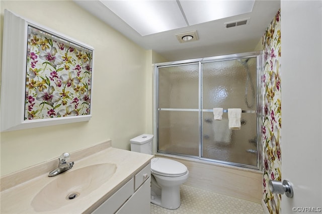 full bathroom featuring combined bath / shower with glass door, vanity, toilet, and tile flooring