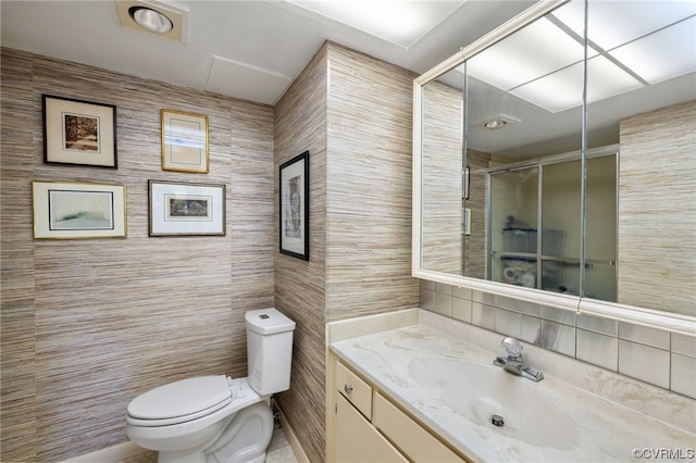 bathroom featuring tile walls, oversized vanity, toilet, and tile flooring