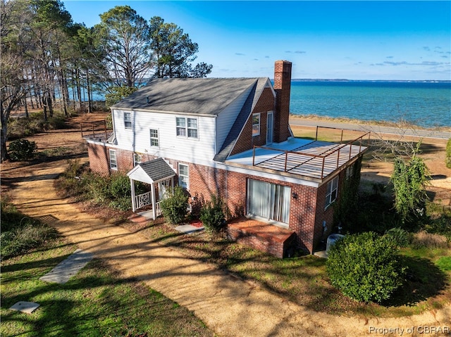 exterior space featuring a front yard and a water view