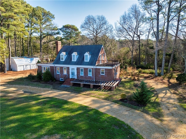 view of front of house with a front yard and an outdoor structure