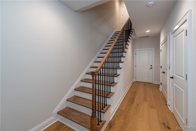 staircase featuring light wood-type flooring