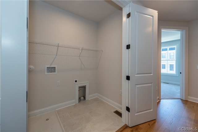 laundry room featuring hookup for an electric dryer, light wood-type flooring, and washer hookup