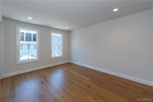 unfurnished room with hardwood / wood-style floors