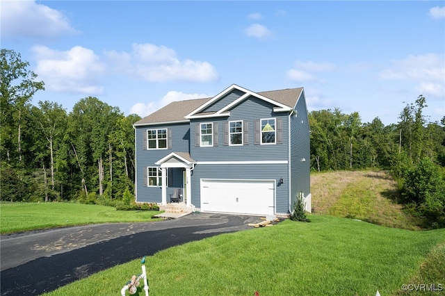 view of front of property featuring a garage and a front lawn