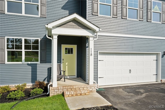 doorway to property featuring a garage