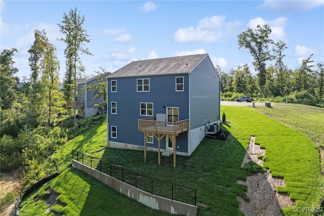 rear view of property with a balcony, a yard, and cooling unit