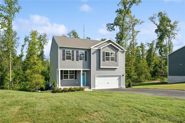 view of property with cooling unit, a garage, and a front lawn