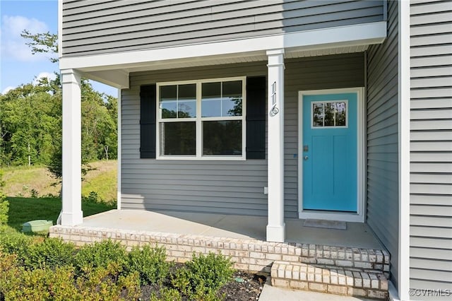 view of exterior entry with a porch