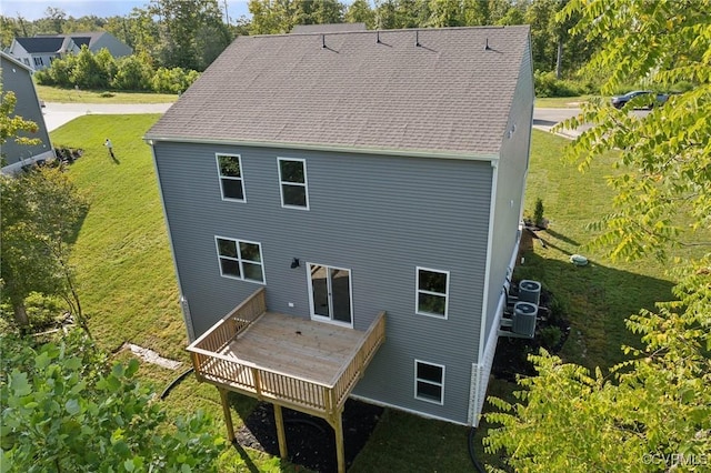 back of house with a deck, central AC, a yard, and roof with shingles