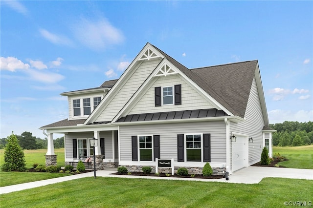 craftsman house featuring a front lawn, a porch, and a garage