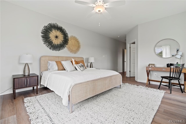 bedroom with ceiling fan and hardwood / wood-style flooring