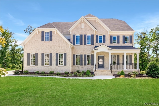 view of front of property with a porch and a front lawn