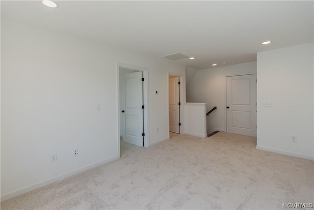 spare room with light colored carpet