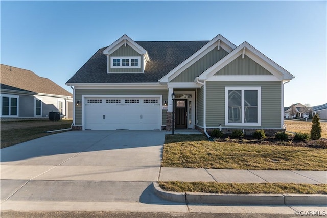 craftsman inspired home featuring a front yard and a garage