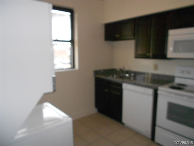 kitchen featuring light tile floors and electric range oven