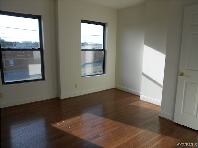 empty room with dark hardwood / wood-style floors