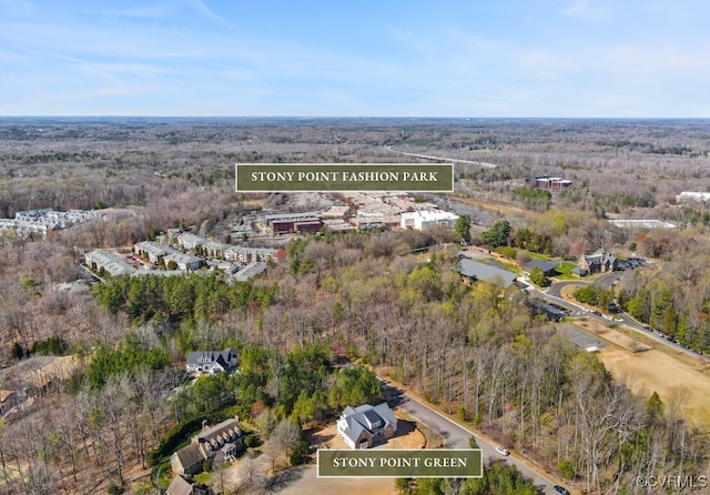 birds eye view of property with a wooded view