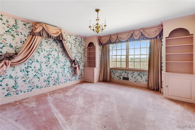 unfurnished bedroom featuring an inviting chandelier, crown molding, and light colored carpet