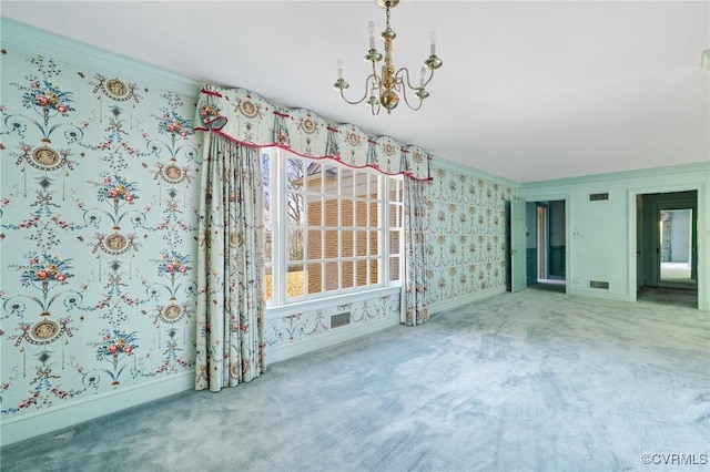 carpeted spare room featuring a notable chandelier