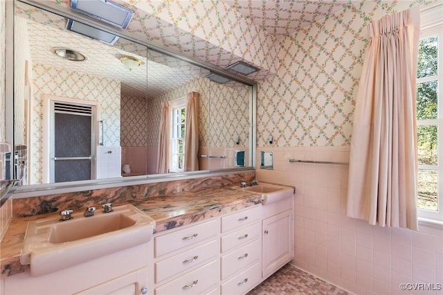 bathroom featuring tile walls, vanity, and a wealth of natural light