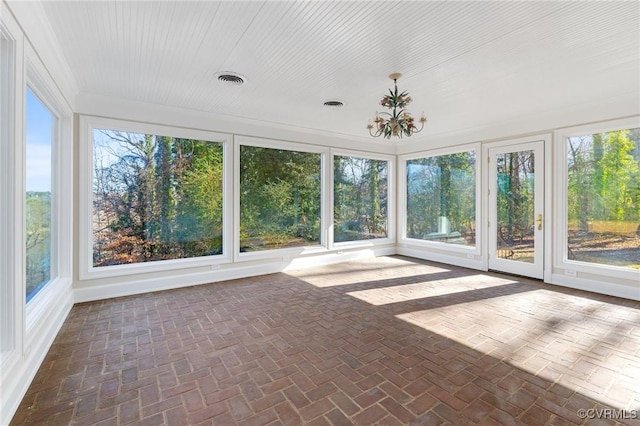 unfurnished sunroom featuring a notable chandelier