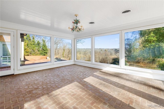 unfurnished sunroom featuring a chandelier