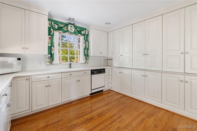 kitchen with white cabinets and paneled dishwasher