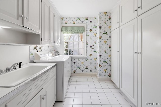 laundry room featuring cabinets, separate washer and dryer, and sink