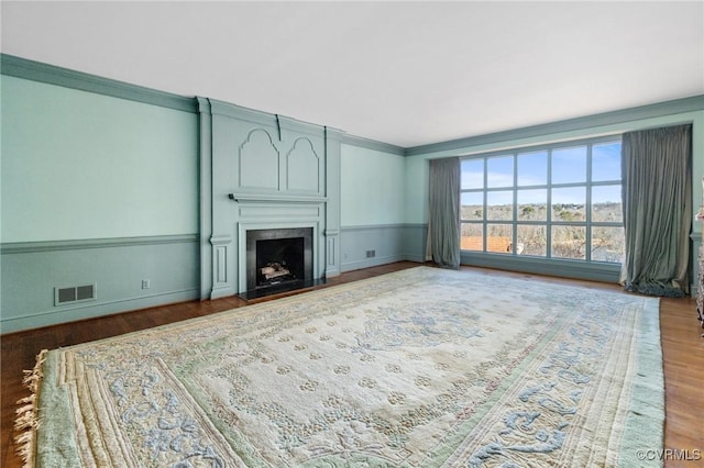 living room featuring hardwood / wood-style flooring and ornamental molding