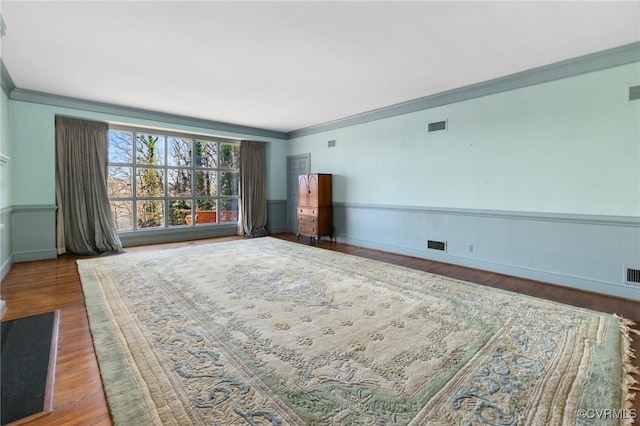 interior space featuring crown molding and hardwood / wood-style floors