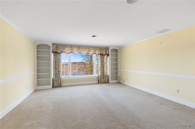 carpeted empty room with ornamental molding and built in features