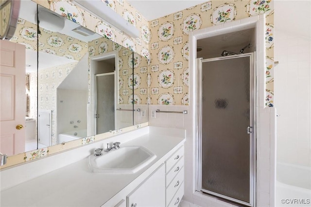 bathroom with vanity, toilet, tile walls, and walk in shower