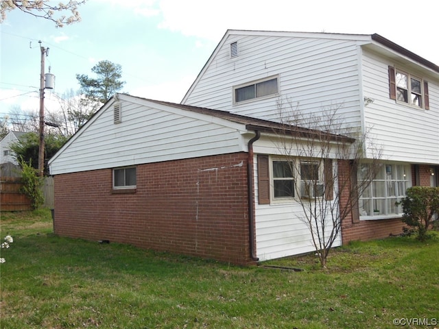 view of side of home with a yard