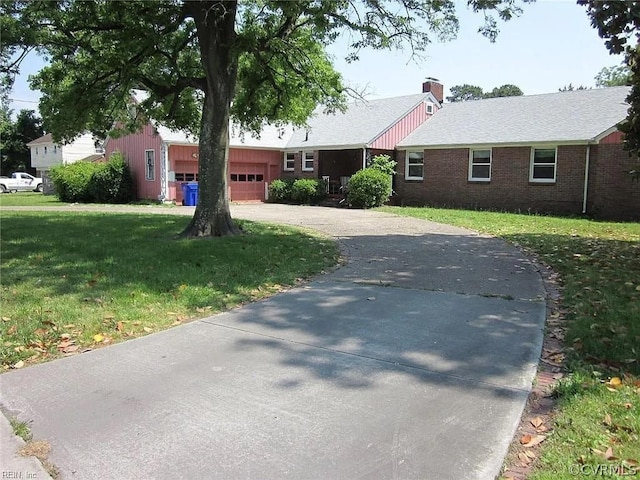 ranch-style house featuring a front lawn and a garage