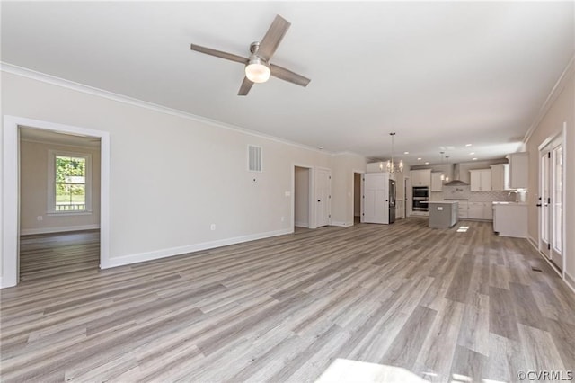 unfurnished living room with sink, light hardwood / wood-style floors, crown molding, and ceiling fan with notable chandelier