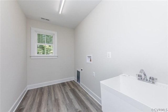 laundry room featuring electric dryer hookup, sink, washer hookup, and hardwood / wood-style flooring