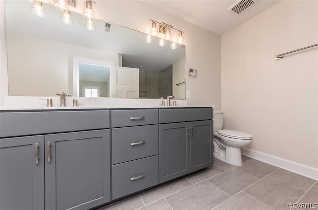 bathroom featuring dual bowl vanity, tile flooring, and toilet