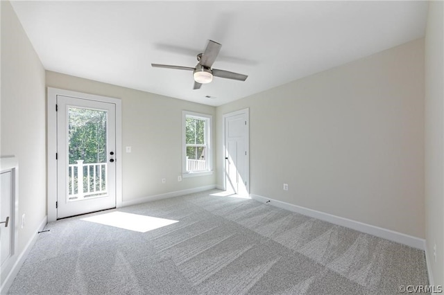 spare room featuring ceiling fan and light colored carpet