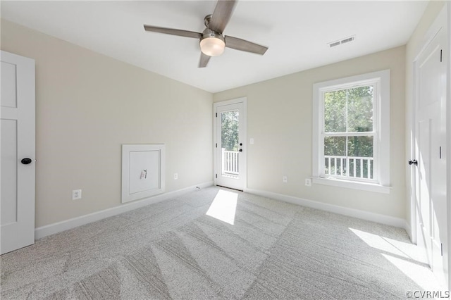 carpeted spare room with ceiling fan