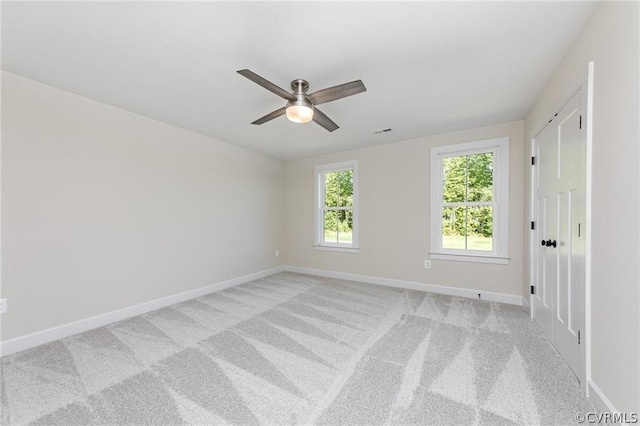 carpeted empty room with ceiling fan