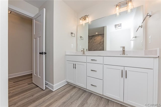 bathroom featuring dual vanity and hardwood / wood-style floors