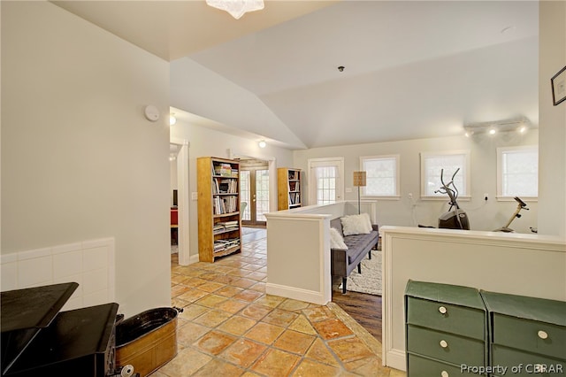 kitchen with light tile patterned floors, vaulted ceiling, and green cabinetry