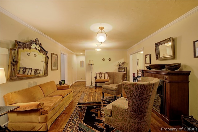 living room with hardwood / wood-style floors and ornamental molding