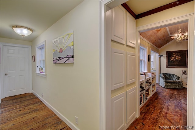 hall with wooden ceiling, dark wood-type flooring, vaulted ceiling, and a notable chandelier