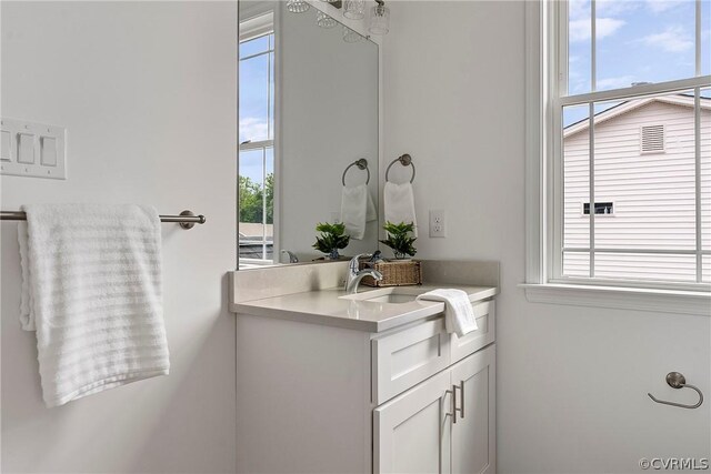 bathroom featuring a healthy amount of sunlight and vanity