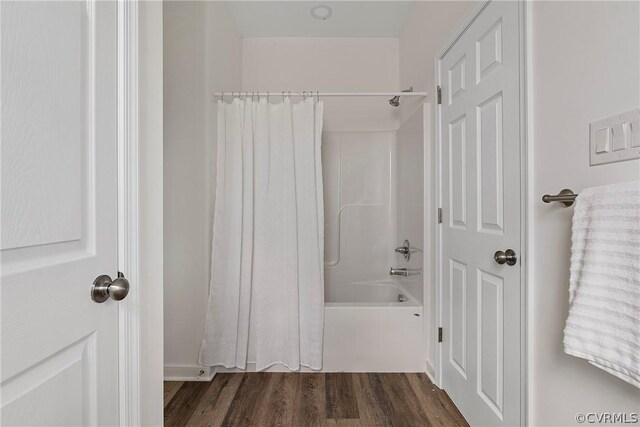 bathroom with shower / bath combo and hardwood / wood-style flooring